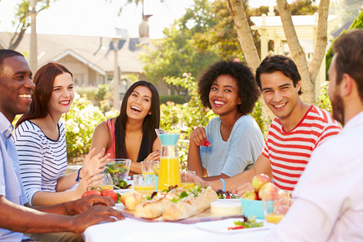 friends enjoying a potluck because tips were followed to prevent bees from crashing summer party